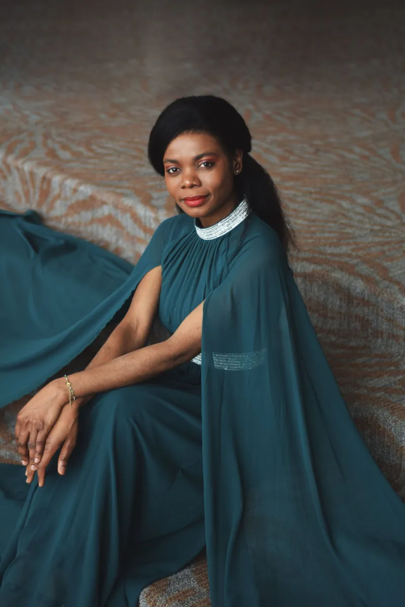 Marie France Koua seated in a green gown